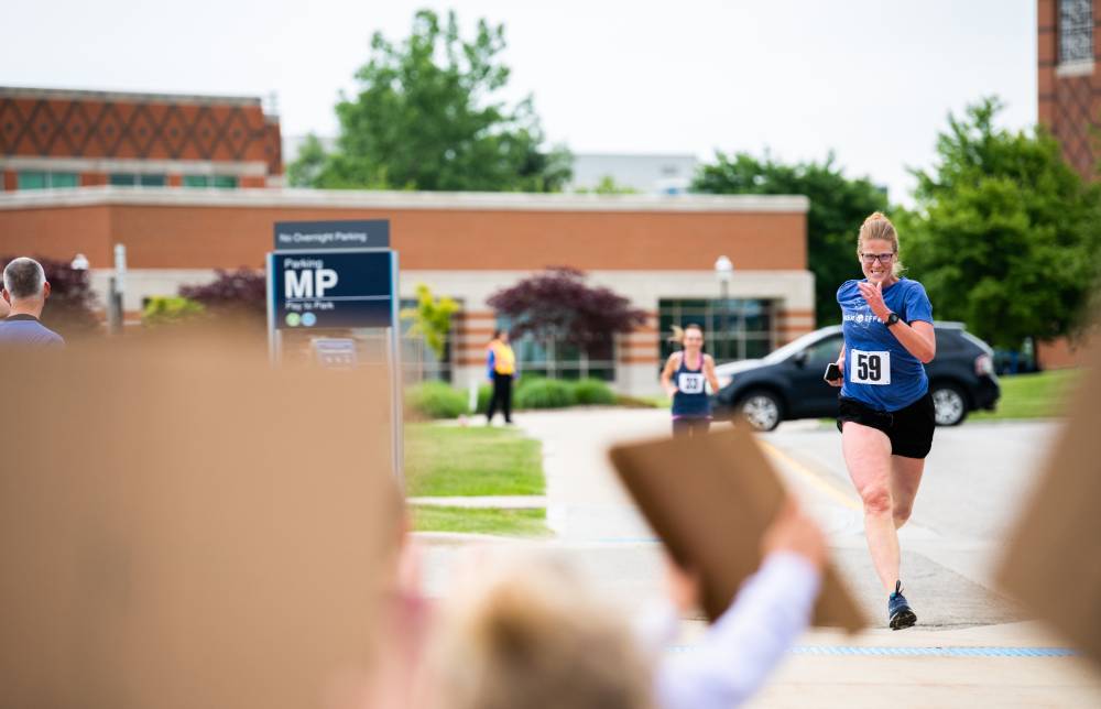 Lisa Maymick determinedly running towards the finish line